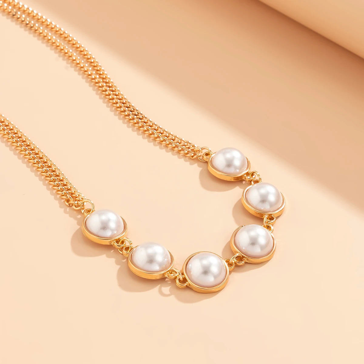 Seductive Elegance: Imitation Pearl Cross Bra and Bikini Waist Chain Set